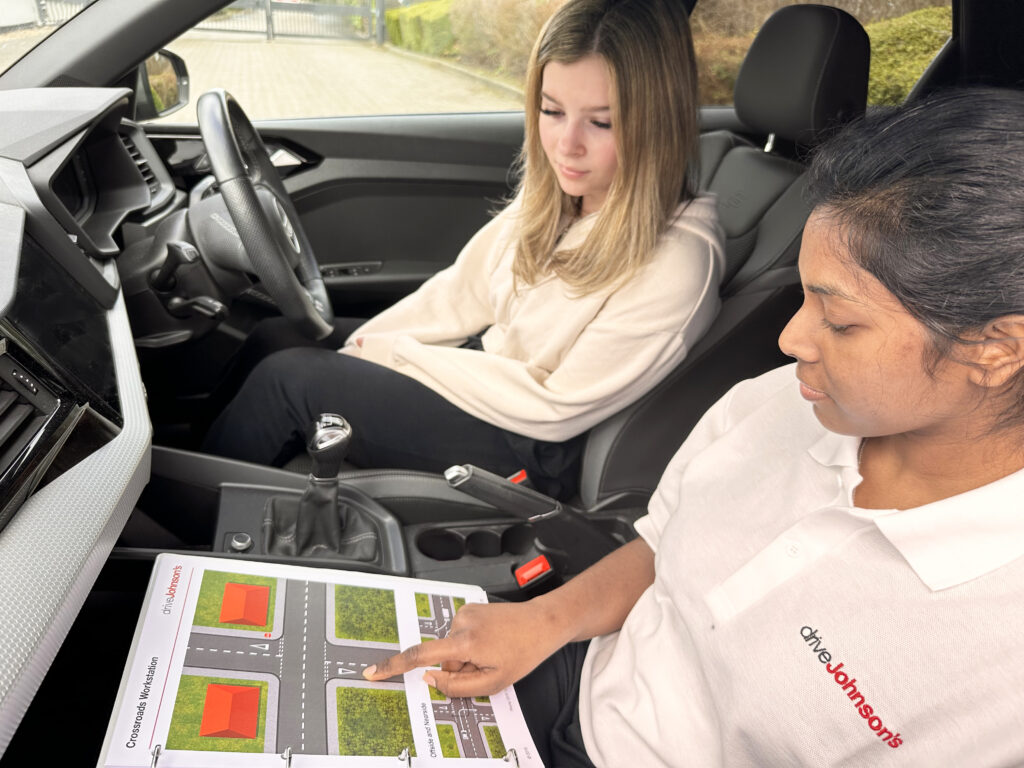 Driving instructor teaching pupil