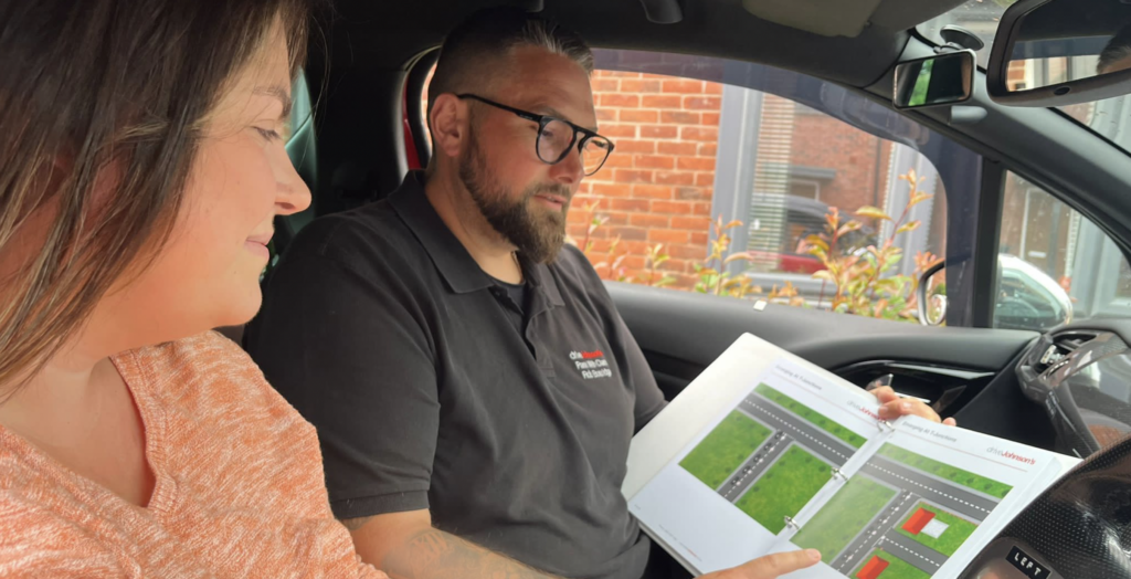 Driving instructor teaching a pupil